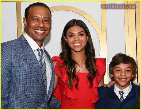 Charlie Woods with his sister and father
